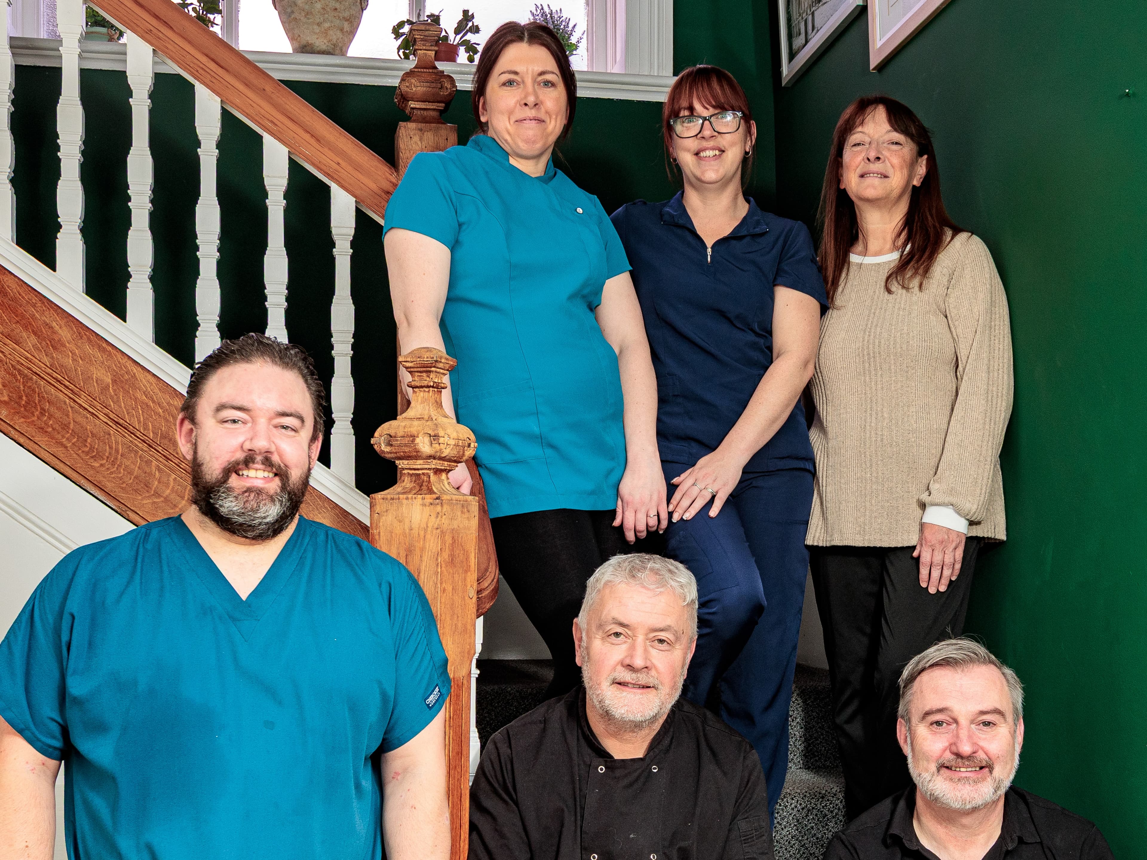 Two smiling residents relaxing in armchairs